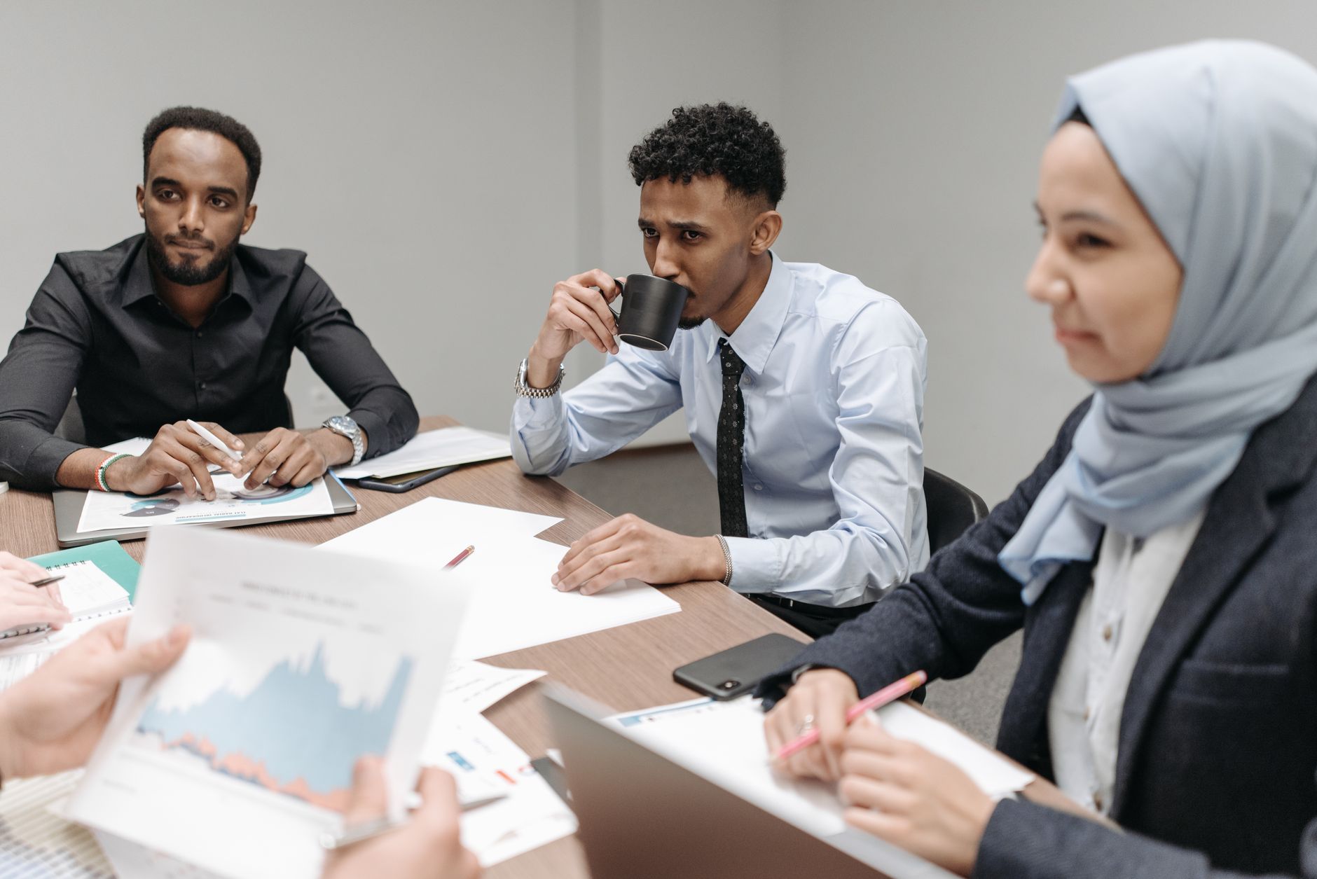 A multicultural team engaged in discussion during an office meeting, highlighting diversity and teamwork. — Durable Wall Pane