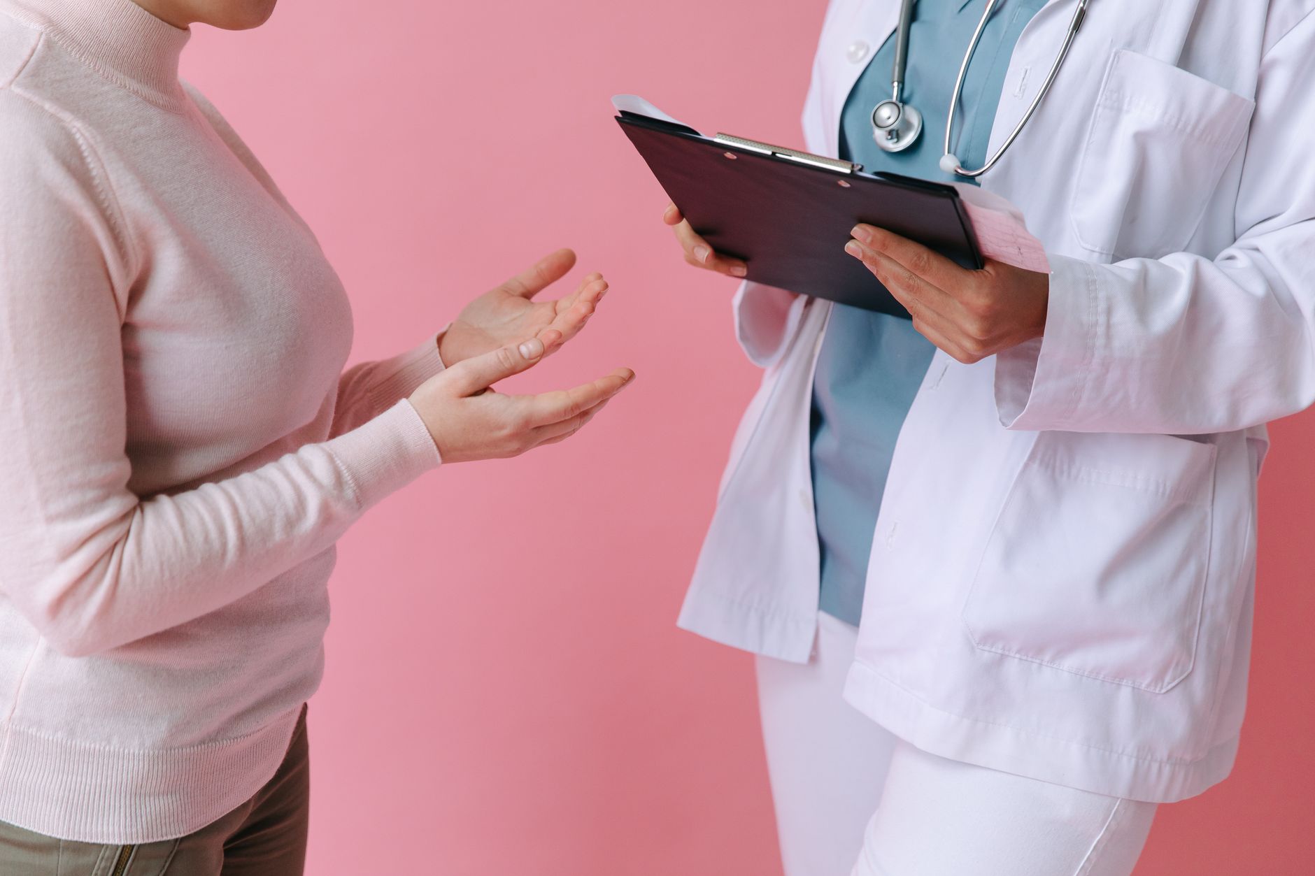 Close-up of a patient consulting a doctor with a clipboard in a medical setting. — PCA Certificate Online Delivers Affordable